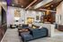 Chic modern living room with a spiral staircase, plush seating, and ambient lighting.