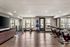 Bright and spacious gym featuring cycling machines, rowing equipment, and fitness balls.