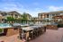 Stunning outdoor area with grilling stations, dining space, and a poolside view.