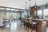 Bright and airy open-concept living area with stylish modern furniture and kitchen bar seating.