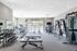 Spacious modern gym with state-of-the-art equipment, natural light, and stylish design.