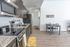 University Pointe, interior, kitchen, wood floor, dark cabinets, stainless steel appliances, stove/oven, dishwasher, refrigerator, lemon floor mat, dining table for two, hallway