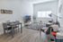 University Pointe, interior, living room, gray leather sofa, black and white area rug, tv, coffee table, dining table for two, window