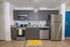 University Pointe, interior, kitchen, wood floor, dark cabinets, stainless steel appliances, stove/oven, dishwasher, refrigerator, lemon floor mat, 'home' 'bon appetit'