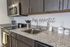 University Pointe, interior, kitchen, dark cabinets, stainless steel oven, microwave, 'bon appetit'