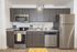 University Pointe, interior, kitchen, wood floor, dark cabinets, stainless steel appliances, stove/oven, dishwasher, refrigerator, lemon floor mat, 'home' 'bon appetit'
