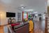 Model apartment living room with hardwood style flooring and white walls