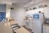 Model apartment kitchen with white appliances, white cabinets, and light counter tops.