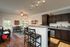 Model kitchen at our apartments in Louisville, featuring granite patterned countertops and wood grain floor paneling.