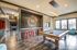 Resident lounge at our apartments in Louisville, featuring dining tables, a coffee station, and flat screen TV.