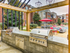 Outdoor lounge at our apartments in Tuscaloosa, featuring two grills, a shade structure, and outdoor chairs.