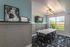 Private study room with a large table, chairs, and flat screen tv for residents to study or work in