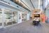 Leasing office with desks, tables, and chairs where staff members can help residents and potential residents with their needs