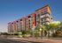 The District on Apache building exterior with the light rail passing by the front of the building