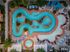 Birds eye view of the lazy river, hot tub, and tanning shelf with sun loungers and umbrellas
