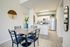 Model kitchen at our student housing in Orlando, featuring wood grain floor paneling and stainless steel appliances.