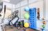 The fitness center at our apartments for rent near Penn State, featuring treadmills, exercise bikes, and ceiling fans.