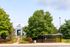 Shuttle stop at our apartments near Penn State, featuring a covered bus stop and entrance to the apartment grounds.