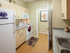 Model kitchen at our apartments near Penn State, featuring wood grain floor paneling and granite patterned countertops.