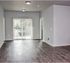 Bright and inviting living area with sleek wood floors and sliding glass doors leading to a balcony.