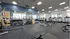 Modern fitness center with state-of-the-art equipment, spacious layout, and large windows for natural light.