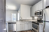 Modern kitchen with sleek stainless steel appliances, granite countertops, and stylish cabinetry, offering a bright and inviting cooking space.