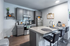 Modern kitchen with sleek gray cabinetry, stainless steel appliances, and a chic granite island with bar seating.