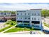 Modern Red Cedar Flats building with contemporary design, surrounded by lush greenery and convenient retail spaces.