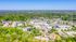 Breathtaking aerial view of a vibrant residential community surrounded by lush greenery and scenic landscapes.