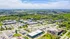 Breathtaking aerial view of a vibrant residential neighborhood surrounded by lush greenery and modern infrastructure.