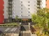 Modern apartment building exterior with sleek design, landscaped entrance, and convenient bike parking at The Quad on Delaware.