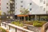 Modern apartment complex entrance with stylish landscaping and sleek architectural design.