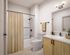 Modern bathroom with sleek fixtures, stylish vanity, and elegant lighting, featuring a chic striped shower curtain.
