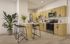 Modern kitchen with sleek wooden cabinetry, stainless steel appliances, and a chic breakfast bar with stylish bar stools.
