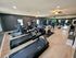 Modern gym with state-of-the-art cardio equipment, spacious workout area, and vibrant decor.