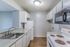 Kitchen with white cabinets and electric range at Deerfield Apartments in Memphis, TN