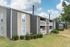 Row of apartment buildings with lawn at Deerfield Apartments in Memphis, TN