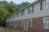 Brick and siding townhome building at Bent Creek Apartments in West Memphis, AR