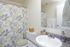 Bathroom with a patterned shower curtain and vanity at Braewood in Murray, UT