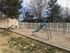 Playground with a green slide and swings at Braewood in Murray, UT