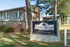 Entrance sign in front of townhomes at Collier Village Apartments in Collierville, TN