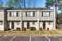 Two-story townhomes with front parking at Collier Village Apartments in Collierville, TN