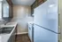 Kitchen with dark cabinets and white appliances at Collier Village Apartments in Collierville, TN