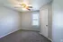 Carpeted primary bedroom with ceiling fan at Collier Village Apartments in Collierville, TN