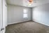 Carpeted second bedroom with window at Collier Village Apartments in Collierville, TN