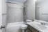 Bathroom with tiled tub and shower at Collier Village Apartments in Collierville, TN