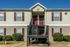 Two-story building with red shutters and stairs at Countryside Village in Memphis, TN