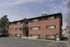 Two-story brick apartments with a paved parking lot at Fairbrook in Salt Lake City, UT