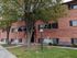 Brick building with a navy awning and shady trees at Fairbrook in Salt Lake City, UT