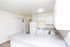 Kitchen and dining area with white appliances at Fairbrook in Salt Lake City, UT